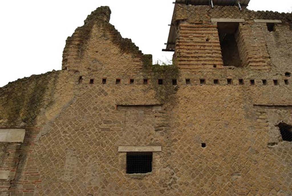 A large brick building with a clock tower
Description generated with high confidence